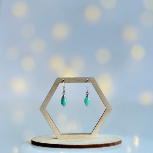 Hexagonal earring stand with marquise cut amazonite drop earrings on a soft blue background
