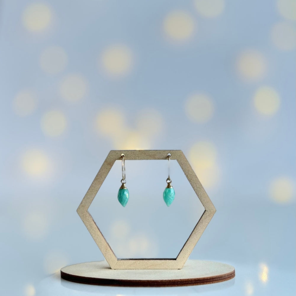 Hexagonal earring stand with marquise cut amazonite drop earrings on a soft blue background