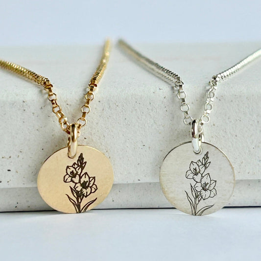 August birth flower necklaces in silver and gold, resting ona white box