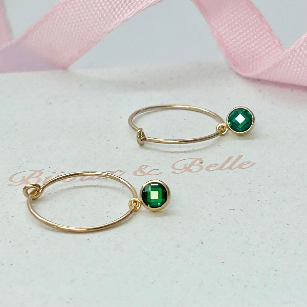 Gold filled hoop earrings with sparkling green crystal drops on a white box, branded with 'Bijoux & Belle'.